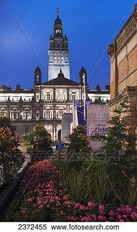 Buildings And A Tower Against A Blue Sky With Flowers And Plants In A Landscaped Garden; Glasgow, Scotland View Large Photo Image Stock Photography - Buildings And A Tower Against A Blue Sky With Flowers And Plants In A Landscaped Garden; Glasgow, Scotland. Fotosearch