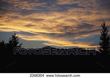 Cirrostratus Clouds Catching A Vibrant Sunset; Alberta, Canada View Large Photo Image Picture - Cirrostratus Clouds Catching A Vibrant Sunset; Alberta, Canada. Fotosearch