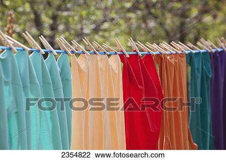 Close Up Of Colourful Clothes Hanging On A Clothes Line With Clothes Pins; Calgary, Alberta, Canada View Large Photo Image Stock Image - Close Up Of Colourful Clothes Hanging On A Clothes Line With Clothes Pins; Calgary, Alberta, Canada. Fotosearch
