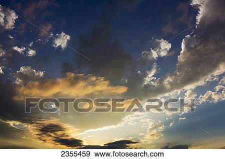Dramatic Sky At Sunset With Warm Glowing Clouds And Blue; Calgary, Alberta, Canada View Large Photo Image Stock Photo - Dramatic Sky At Sunset With Warm Glowing Clouds And Blue; Calgary, Alberta, Canada. Fotosearch