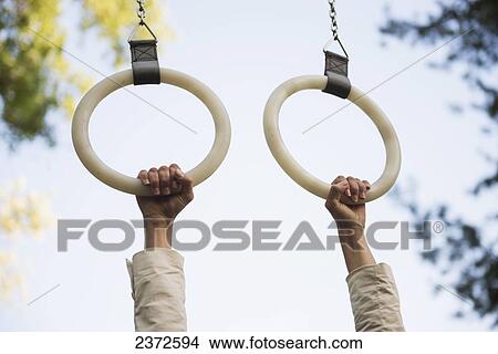 Hands Holding On To Hanging Gymnastic Rings; Locarno, Ticino, Switzerland View Large Photo Image Picture - Hands Holding On To Hanging Gymnastic Rings; Locarno, Ticino, Switzerland. Fotosearch
