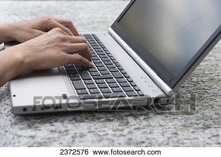 Hands Typing On A Laptop Computer; Locarno, Ticino, Switzerland View Large Photo Image Stock Photograph - Hands Typing On A Laptop Computer; Locarno, Ticino, Switzerland. Fotosearch