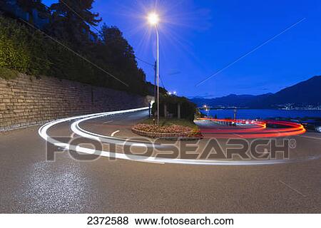 Stock Photo - Light Trails Of Vehicle Headlights And Taillights On A Road; Locarno, Ticino, Switzerland. Fotosearch