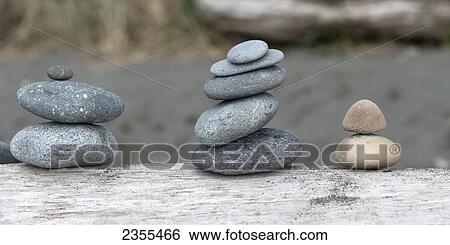 Piles Of Small Rocks On Driftwood; Oak Harbor, Washington, United States Of America View Large Photo Image Stock Photograph - Piles Of Small Rocks On Driftwood; Oak Harbor, Washington, United States Of America. Fotosearch