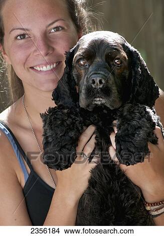Portrait Of A Woman Holding Her Cocker Spaniel; Mayne Island, British Columbia, Canada View Large Photo Image Picture - Portrait Of A Woman Holding Her Cocker Spaniel; Mayne Island, British Columbia, Canada. Fotosearch