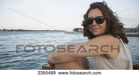 Portrait Of A Woman Sitting On The Water's Edge; Utila, Bay Islands, Honduras View Large Photo Image Stock Photo - Portrait Of A Woman Sitting On The Water's Edge; Utila, Bay Islands, Honduras. Fotosearch