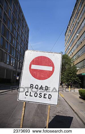 Road Closed Sign On A Road Between Two Buildings; Toronto, Ontario, Canada View Large Photo Image Stock Image - Road Closed Sign On A Road Between Two Buildings; Toronto, Ontario, Canada. Fotosearch
