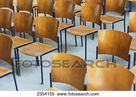 Stock Photography - Rows Of Empty Wooden Chairs Set Up For A Conference; Oahu, Hawaii, United States Of America. Fotosearch