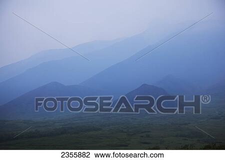 Smoke From A Forest Fire Creates A Blue Haze That Partially Obscures Mountains In Denali National Park And Preserve; Alaska, United States Of America View Large Photo Image Stock Image - Smoke From A Forest Fire Creates A Blue Haze That Partially Obscures Mountains In Denali National Park And Preserve; Alaska, United States Of America. Fotosearch