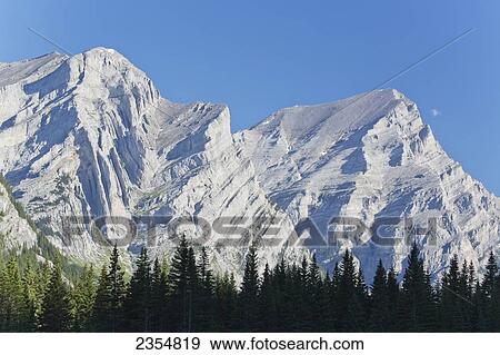 Stock Photo - Snow Covered Canadian Rocky Mountains With A Forest Below The Peaks; Kananaskis, Alberta, Canada. Fotosearch