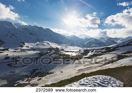 Sunlight Shining On The Mountains At A High Elevation; San Gottardo, Ticino, Switzerland View Large Photo Image Stock Photo - Sunlight Shining On The Mountains At A High Elevation; San Gottardo, Ticino, Switzerland. Fotosearch