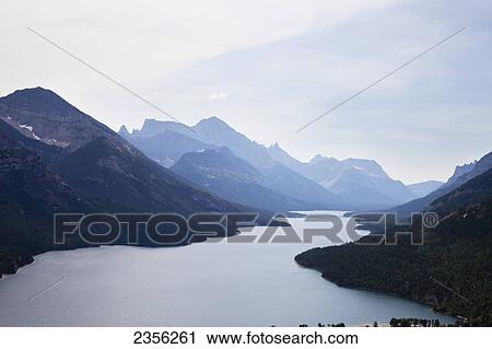 The Canadian Rockies And The Blue Waters Of Waterton Lakes Collide; Alberta, Canada View Large Photo Image Stock Image - The Canadian Rockies And The Blue Waters Of Waterton Lakes Collide; Alberta, Canada. Fotosearch