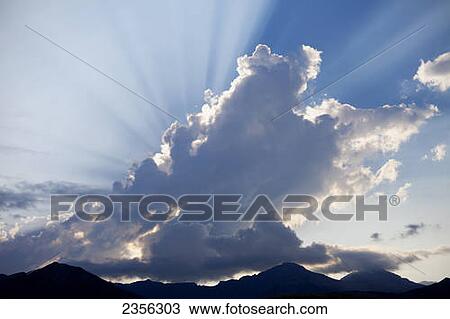 The Hidden Sun Escapes In Ray Among The Clouds Above Waterton Lakes National Park; Alberta, Canada View Large Photo Image Stock Image - The Hidden Sun Escapes In Ray Among The Clouds Above Waterton Lakes National Park; Alberta, Canada. Fotosearch