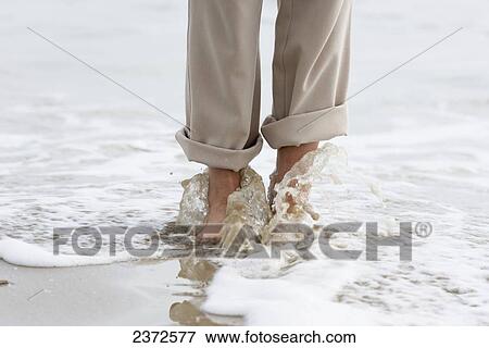 Walking Barefoot Along The Beach With Water Washing Over Feet; Rimini, Emilia-Romagna, Italy View Large Photo Image Stock Photo - Walking Barefoot Along The Beach With Water Washing Over Feet; Rimini, Emilia-Romagna, Italy. Fotosearch