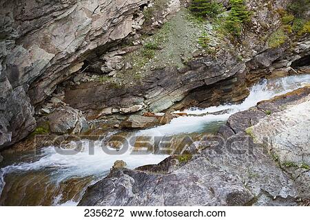 Water Flowing Over A Rocky Landscape In Waterton Lakes National Park; Alberta, Canada View Large Photo Image Stock Image - Water Flowing Over A Rocky Landscape In Waterton Lakes National Park; Alberta, Canada. Fotosearch