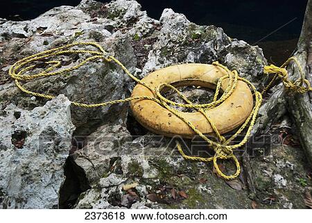 Yellow safety ring on the rocks; Tulum, Mexico View Large Photo Image Stock Photo - Yellow safety ring on the rocks; Tulum, Mexico. Fotosearch