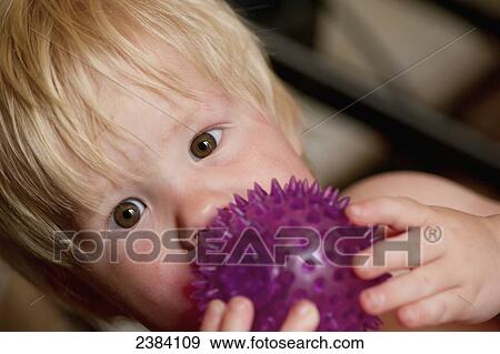 A baby boy plays with a ball; Alberta, Canada View Large Photo Image Stock Photo - A baby boy plays with a ball; Alberta, Canada. Fotosearch