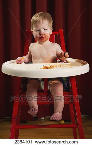 A baby boy sits in a high chair eating a messy meal of spaghetti; Alberta, Canada View Large Photo Image Stock Image - A baby boy sits in a high chair eating a messy meal of spaghetti; Alberta, Canada. Fotosearch