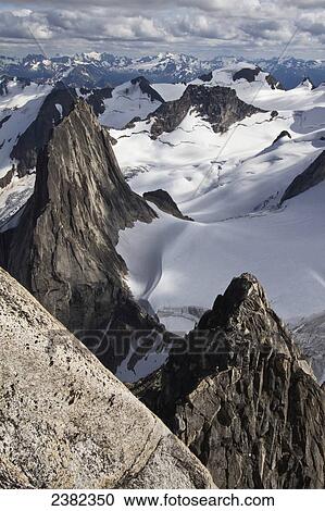 Stock Image - A climber descending the Kaine Route on Bugaboo Spire, Purcell Range, Columbia Mountains; British Columbia, Canada. Fotosearch
