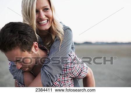 A couple being playful; Victoria, British Columbia, Canada View Large Photo Image Stock Image - A couple being playful; Victoria, British Columbia, Canada. Fotosearch