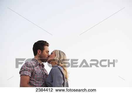 Stock Image - A couple kissing; Victoria, British Columbia, Canada. Fotosearch