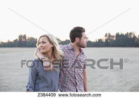 A couple walking in an embrace along the water's edge; Victoria, British Columbia, Canada View Large Photo Image Stock Photo - A couple walking in an embrace along the water's edge; Victoria, British Columbia, Canada. Fotosearch