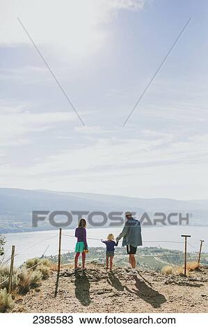 A family stands together overlooking a view of Lake Okanagan; Peachland, British Columbia, Canada View Large Photo Image Stock Image - A family stands together overlooking a view of Lake Okanagan; Peachland, British Columbia, Canada. Fotosearch