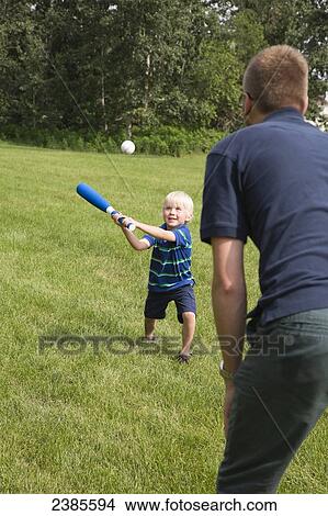 A father plays baseball with his young son in the park; Stony Plain, Alberta, Canada View Large Photo Image Picture - A father plays baseball with his young son in the park; Stony Plain, Alberta, Canada. Fotosearch