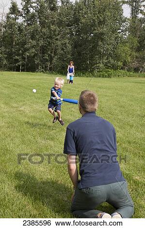 A father plays baseball with his young son in the park; Stony Plain, Alberta, Canada View Large Photo Image Stock Photograph - A father plays baseball with his young son in the park; Stony Plain, Alberta, Canada. Fotosearch
