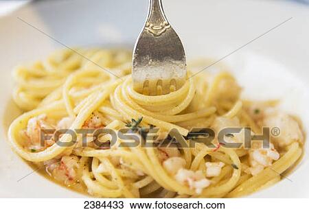 Stock Image - A fork in a pasta dish; Liguria, Italy. Fotosearch