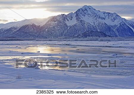 Stock Photography - A late winter sunrise over Pioneer Peak; Palmer, Alaska, United States of America. Fotosearch