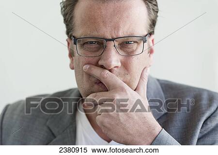 Stock Photography - A man in a thinking pose; Locarno, Ticino, Switzerland. Fotosearch