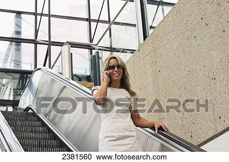A mature professional businesswoman in a downtown office environment using cell phone; Edmonton, Alberta, Canada View Large Photo Image Stock Image - A mature professional businesswoman in a downtown office environment using cell phone; Edmonton, Alberta, Canada. Fotosearch