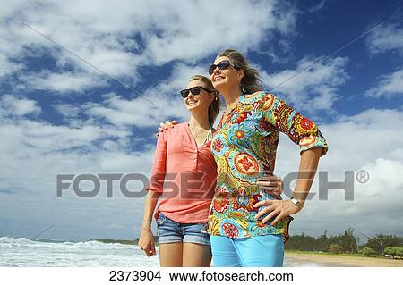 Picture - A mother and daughter together on the beach; Kauai, Hawaii, United States of America. Fotosearch