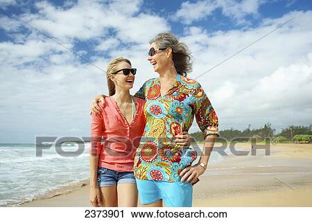 A mother and daughter together on the beach; Kauai, Hawaii, United States of America View Large Photo Image Stock Image - A mother and daughter together on the beach; Kauai, Hawaii, United States of America. Fotosearch