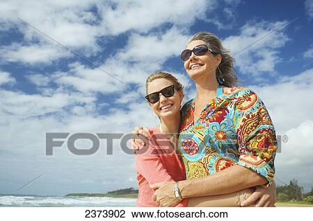 A mother and daughter together on the beach; Kauai, Hawaii, United States of America View Large Photo Image Stock Image - A mother and daughter together on the beach; Kauai, Hawaii, United States of America. Fotosearch