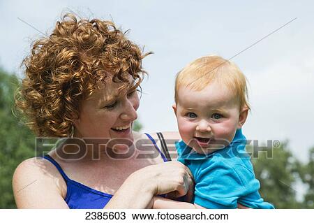 Stock Image - A mother plays with her young son; Stony Plain, Alberta, Canada. Fotosearch