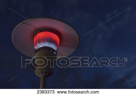 Stock Image - A propane torch lamp is lit at night; Fort McMurray, Alberta, Canada. Fotosearch