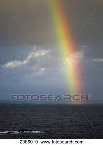 Stock Image - A rainbow appears over the ocean; Charleston, Oregon, United States of America. Fotosearch