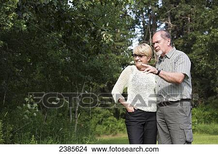 A senior couple in a park; Stony Plain, Alberta, Canada View Large Photo Image Picture - A senior couple in a park; Stony Plain, Alberta, Canada. Fotosearch
