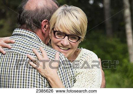 Stock Photograph - A senior couple in an embrace; Stony Plain, Alberta, Canada. Fotosearch