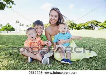 A single mother with her three children sons sitting at a grassy park; Honolulu, Oahu, Hawaii, United States of America View Large Photo Image Stock Photo - A single mother with her three children sons sitting at a grassy park; Honolulu, Oahu, Hawaii, United States of America. Fotosearch