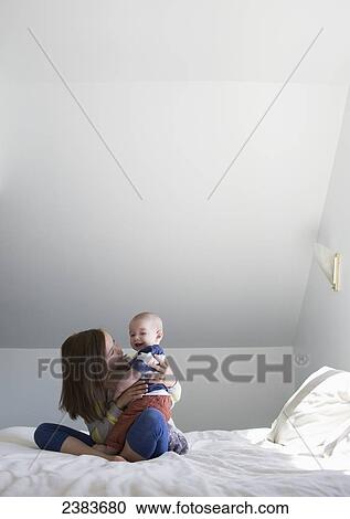 A sister playing with her baby brother on a bed at home; Victoria, British Columbia, Canada View Large Photo Image Stock Image - A sister playing with her baby brother on a bed at home; Victoria, British Columbia, Canada. Fotosearch