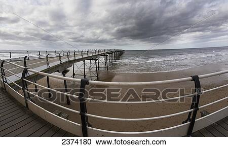 Stock Image - A walkway leading out to the ocean; Saltburn, North Yorkshire, England. Fotosearch