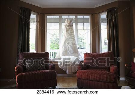 A wedding dress hanging in the window of a home; British Columbia, Canada View Large Photo Image Stock Photograph - A wedding dress hanging in the window of a home; British Columbia, Canada. Fotosearch