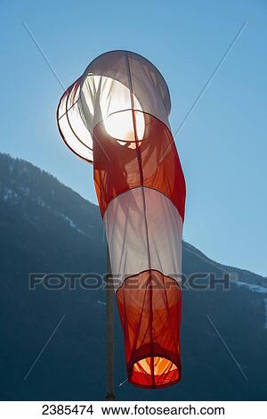 Picture - A windsock against a blue sky; Locarno, Ticino, Switzerland. Fotosearch
