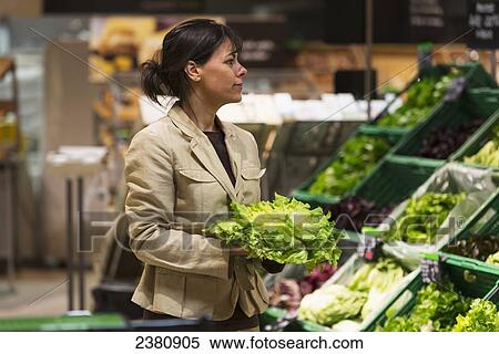 A woman buying fresh produce in a store; Ascona, Ticino, Switzerland View Large Photo Image Stock Photography - A woman buying fresh produce in a store; Ascona, Ticino, Switzerland. Fotosearch