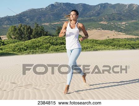 A woman jogging barefoot on the beach; Tarifa, Cadiz, Andalusia, Spain View Large Photo Image Stock Photography - A woman jogging barefoot on the beach; Tarifa, Cadiz, Andalusia, Spain. Fotosearch