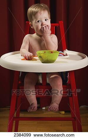 A young boy sits in his highchair eating a meal; Alberta, Canada View Large Photo Image Stock Photo - A young boy sits in his highchair eating a meal; Alberta, Canada. Fotosearch