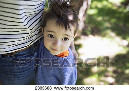A young boy stands beside his parent; Victoria, British Columbia, Canada View Large Photo Image Stock Photo - A young boy stands beside his parent; Victoria, British Columbia, Canada. Fotosearch